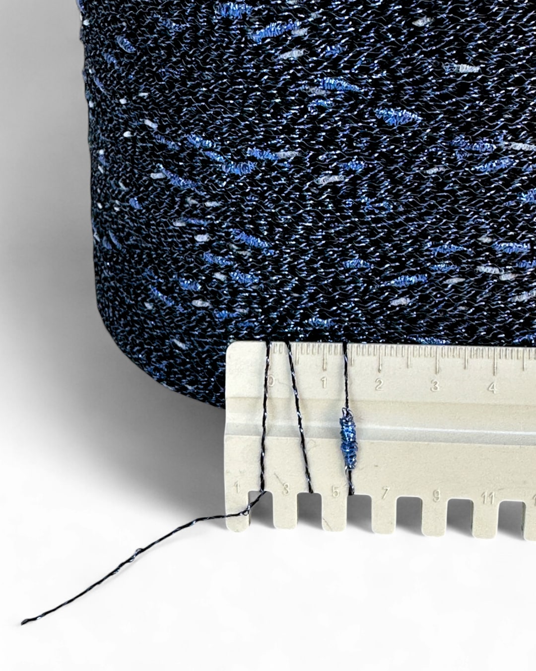 Close-up of a textured fabric with a ruler showing measurements