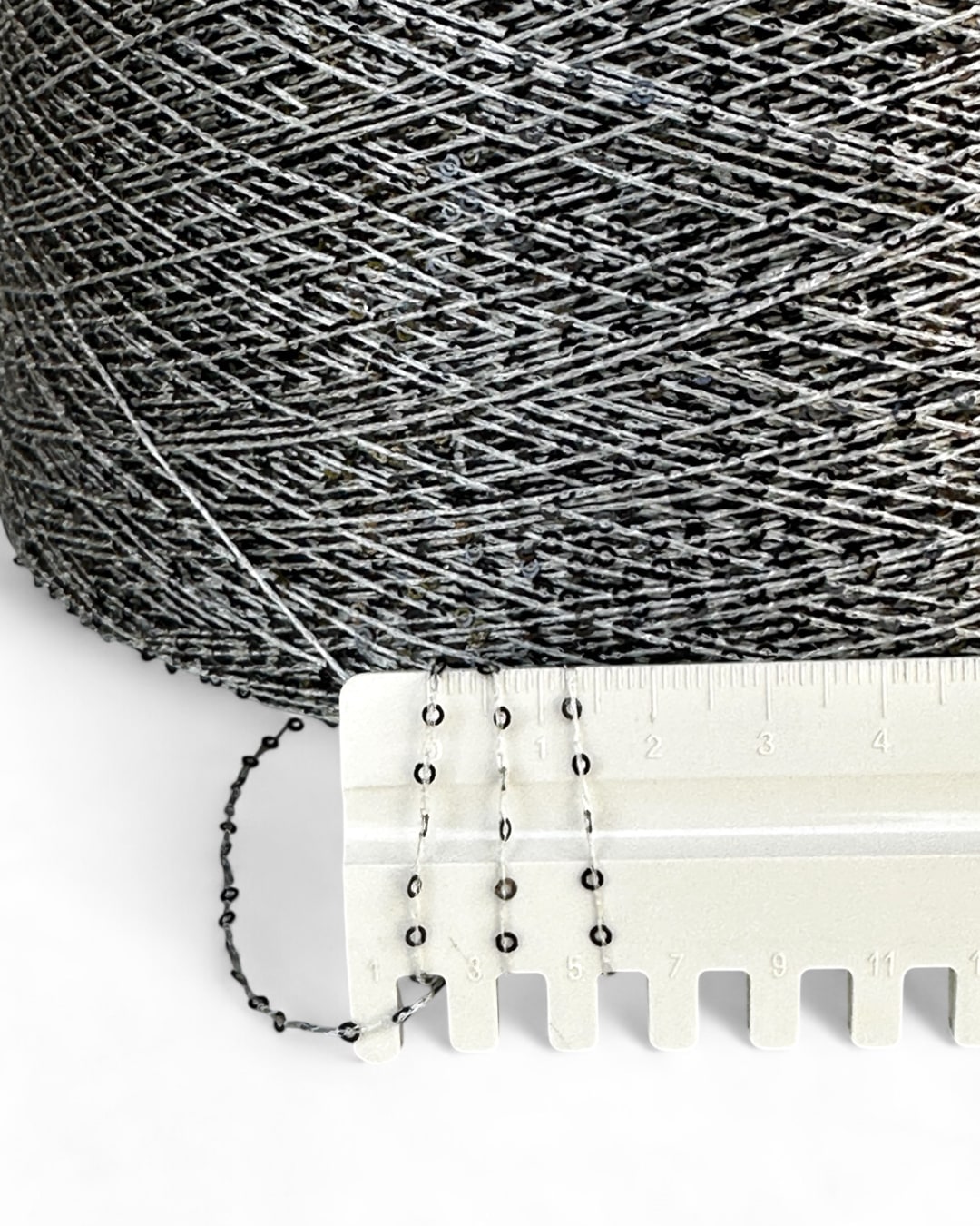Close-up with ruler showing deep grey sequins