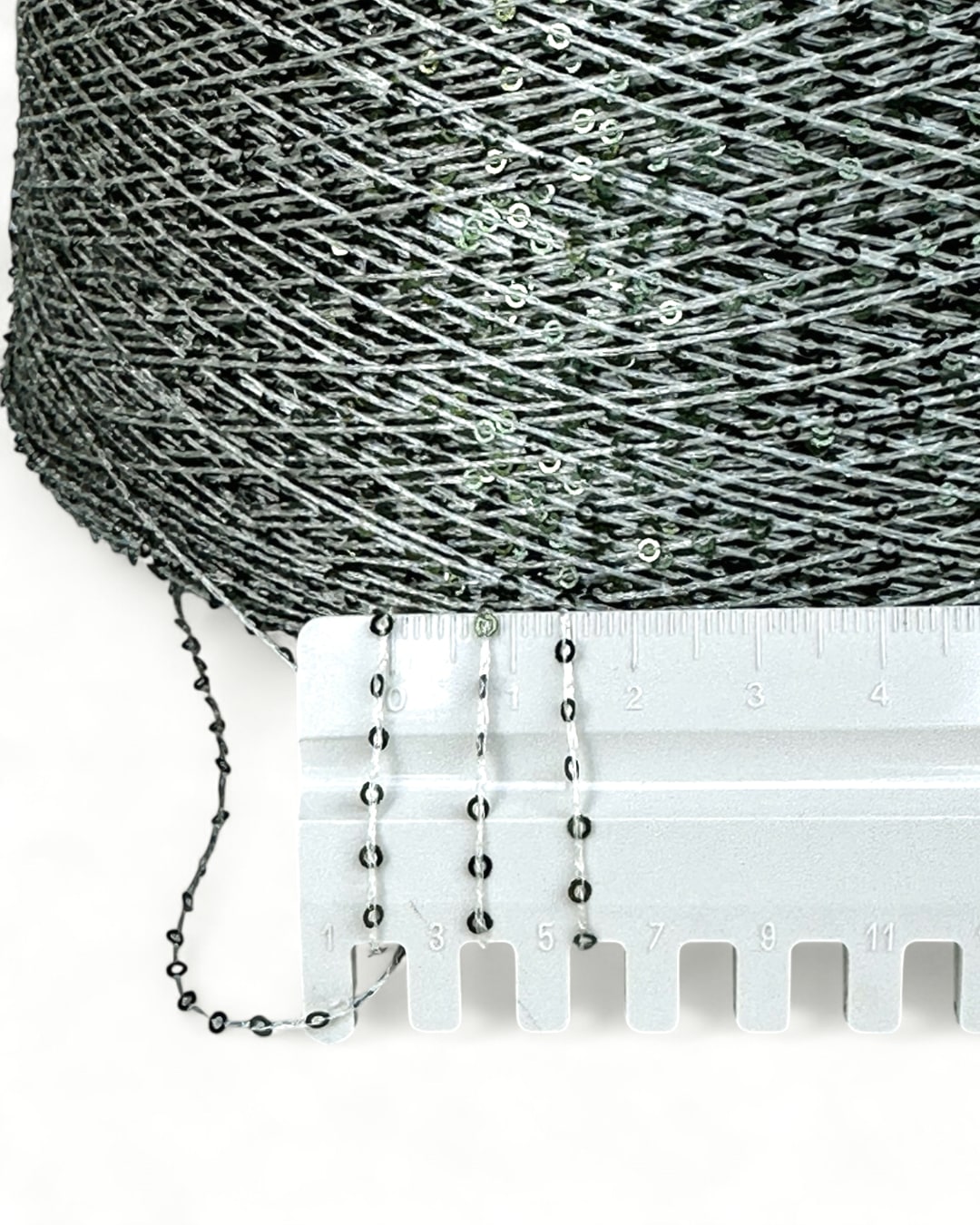 Close-up with ruler showing frosty green sequins
