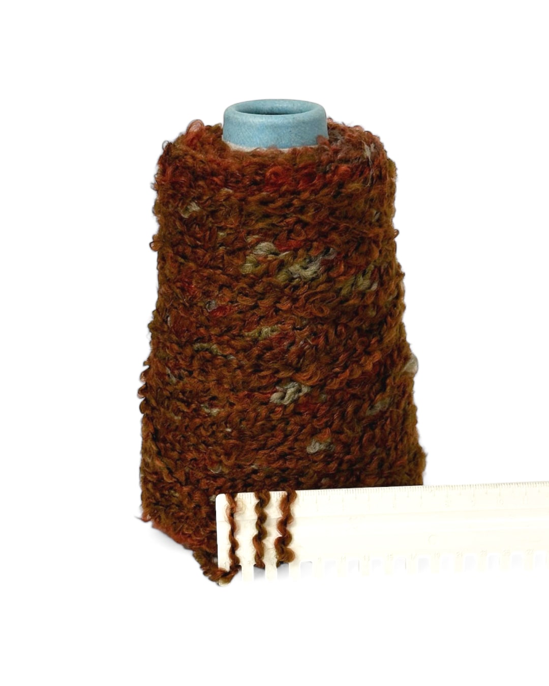 Close-up of “Autumn Terracotta” yarn on ruler