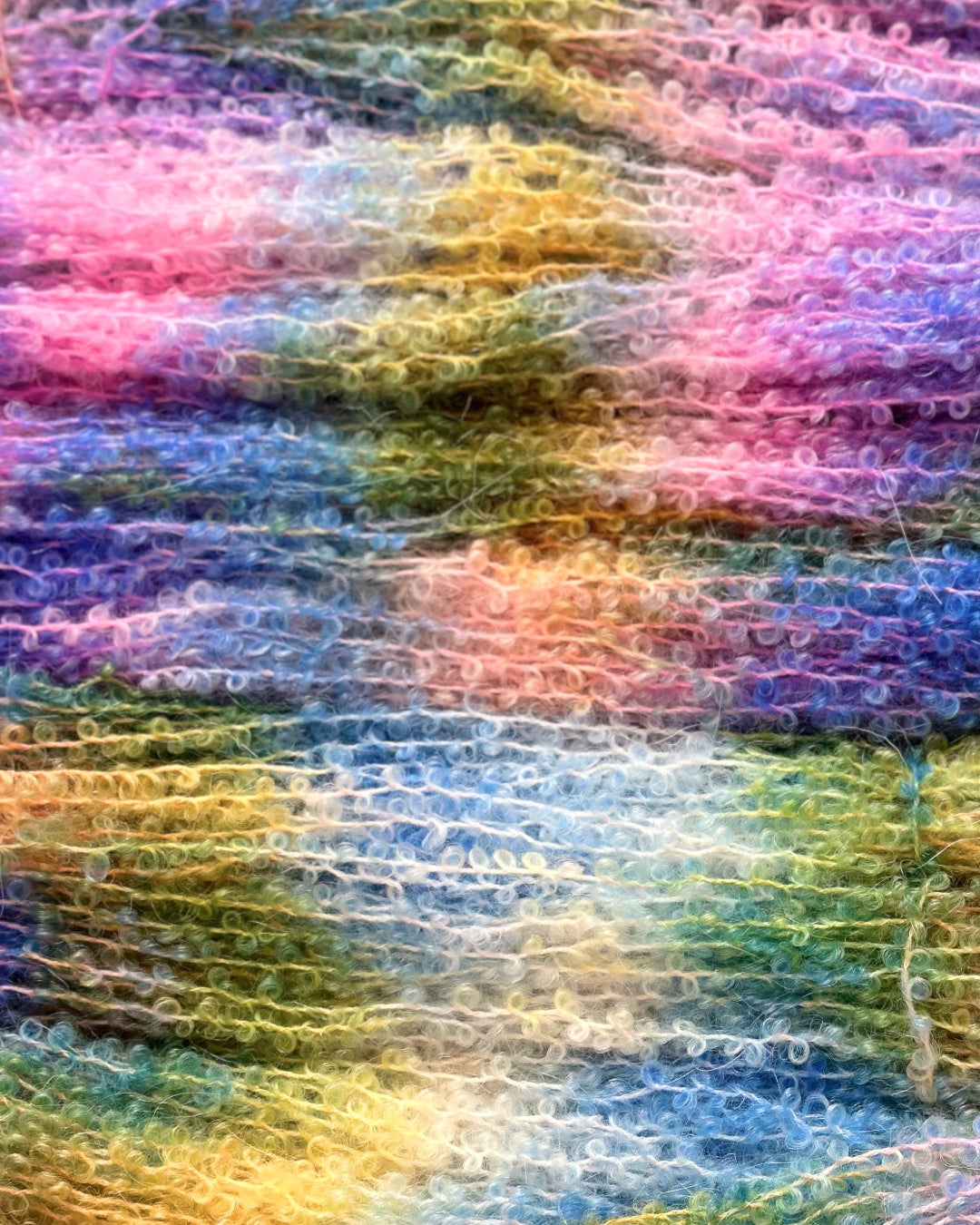 Soft and silky hand-dyed yarn skein featuring a vibrant multicolor palette with 75% kid mohair and 25% silk composition.