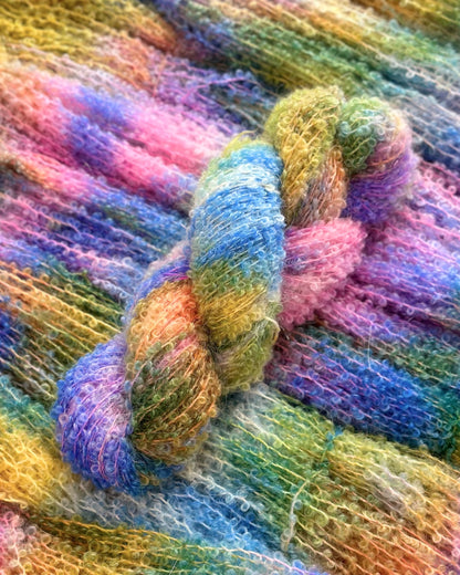 Artisanal multicolored yarn made from a plush blend of kid mohair and silk, ideal for knitting projects; measures 250m/100g