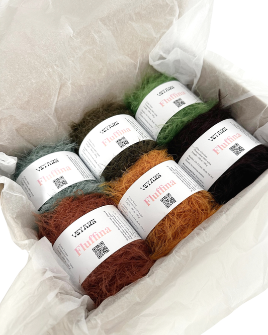 Yarn balls with labels in a white box