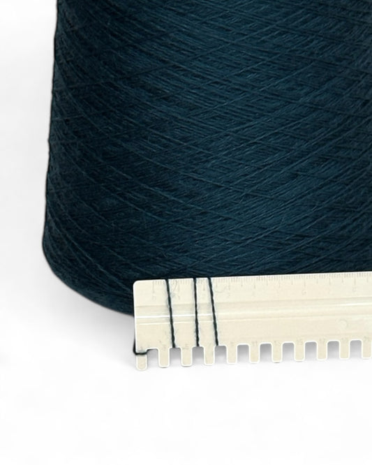 Cone of fine yarn, dark blue-green shade