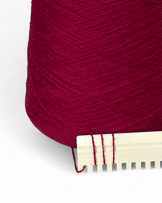 Cone of fine Italian yarn in rich raspberry tone