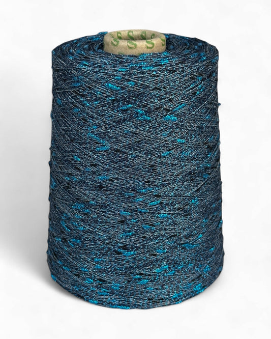 Stellina yarn in Frosted Sky — light beige-grey base with icy blue knots, cone and close-up with ruler
