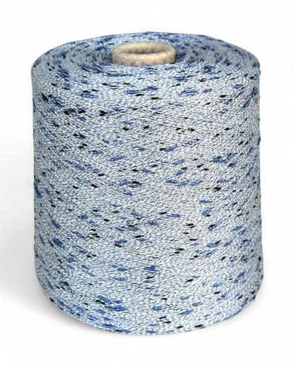 Stellina yarn in Winter Ash — pale grey base with cornflower blue and black sparkle knots, cone and close-up with ruler