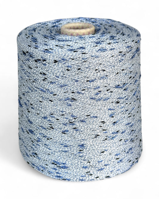 Stellina yarn in Winter Ash — pale grey base with cornflower blue and black sparkle knots, cone and close-up with ruler