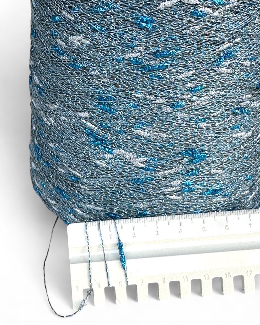 Close-up of Stellina Ice Flash yarn and ruler showing knot texture