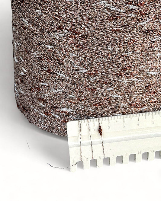 Textured brown fabric with a ruler for scale on a white background