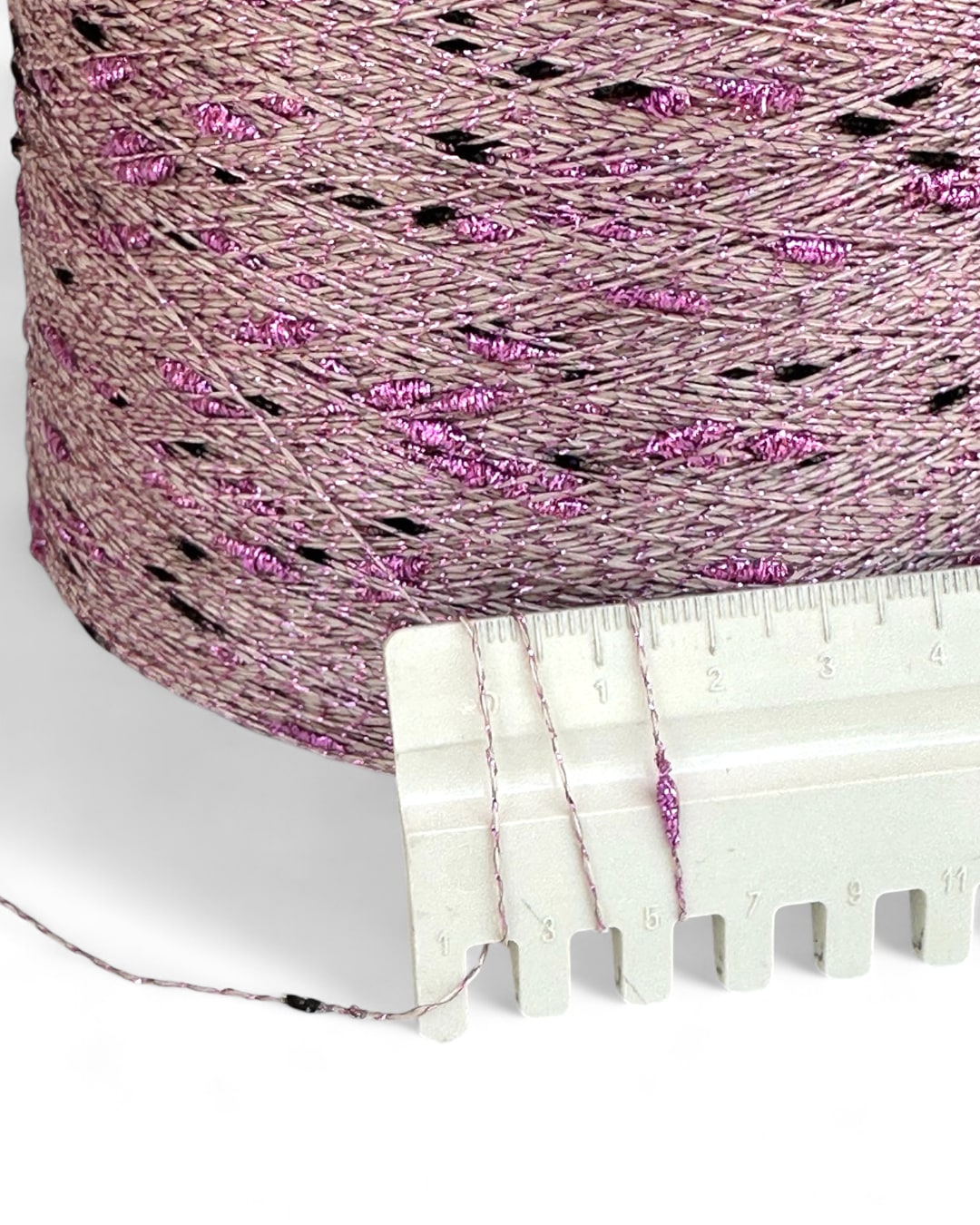 Close up of Stellina Misty Morning yarn with ruler