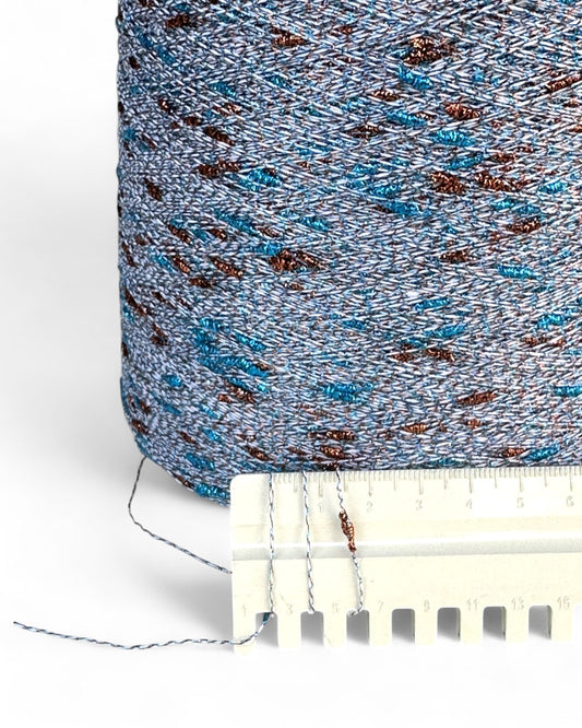 Close-up of blue and brown yarn with a white plastic tool on a white background