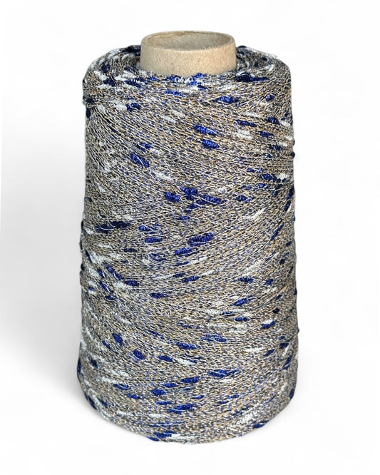 Stellina yarn in Royal Sand — sandy base with silver and blue sparkle knots, cone and close-up with ruler