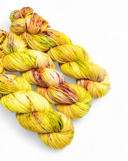 Filato tinto a mano “Limoncella” in lana merino 100%, 300 m / 100 g, base gialla solare con spruzzi.