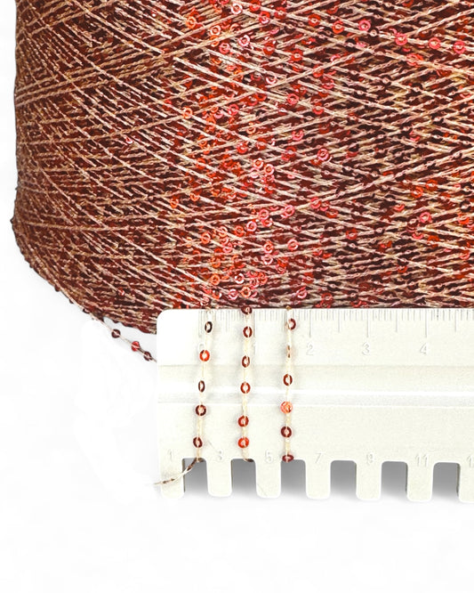 Close-up with ruler showing ruby sequins