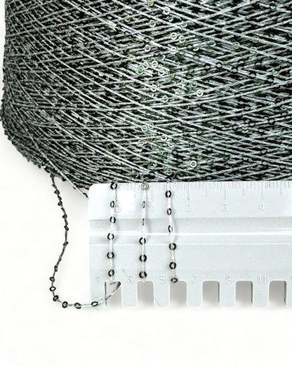 Close-up with ruler showing frosty green sequins