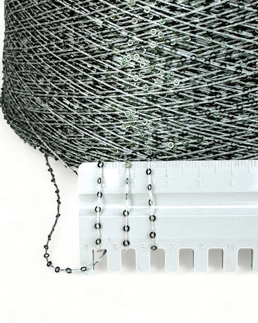 Close-up with ruler showing frosty green sequins