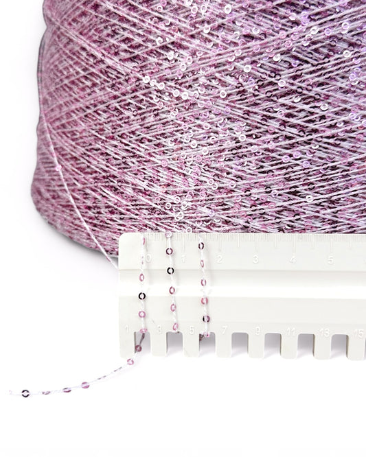 Close-up of “Blush Sparkle” yarn and ruler showing structure and sequin detail
