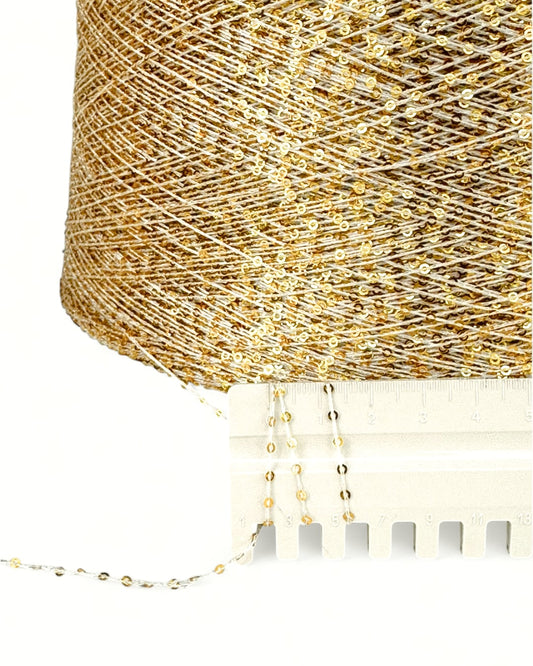 Close-up of Golden Aura with ruler — light thread and golden sequins