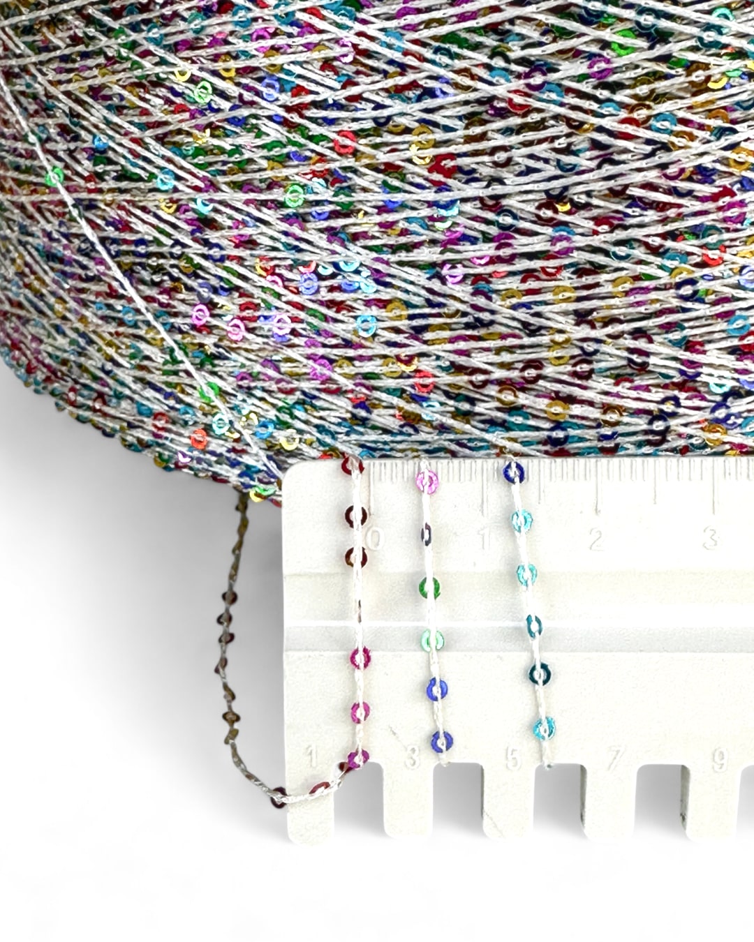 Close-up with ruler showing multicolor sequins