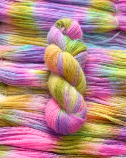 Soft and luxurious yarn blend featuring super baby alpaca, merino wool, and nylon. With 400m per 100g, this variegated yarn showcases beautiful shades of pink, purple, yellow, and green.