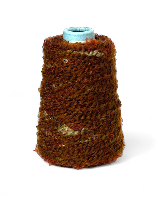 Cone of boucle yarn in autumn terracotta shades